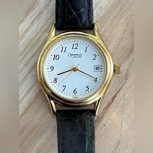Caravelle by Bulova Ladies Watch White Dial Black Leather Strap Date Window